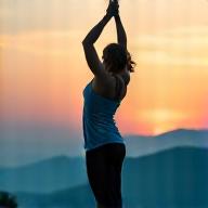 A person practicing gentle yoga outdoors, symbolizing graceful aging and vitality.
